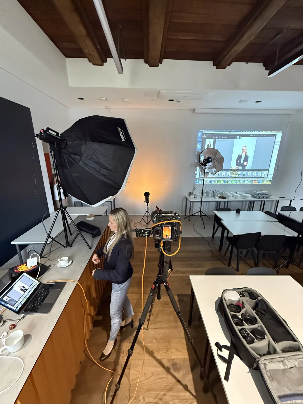 Portrait set-up in an office: lights, a camera on a tripod and the shots on screen