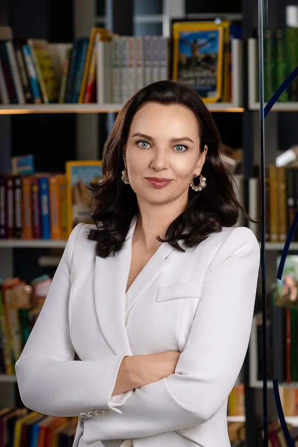 Portrait of a manager in a white blazer in an office