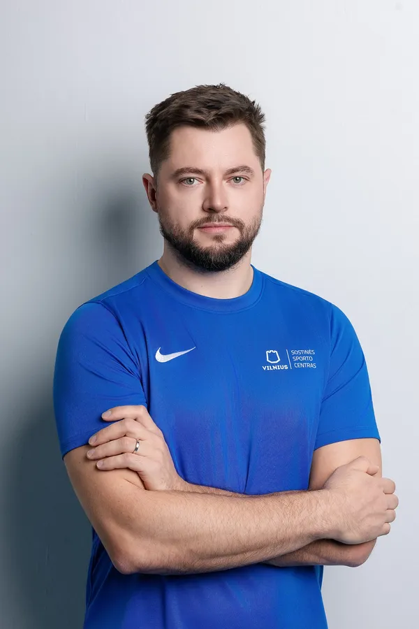 Portrait of a man in a sports centre T-shirt on a light background