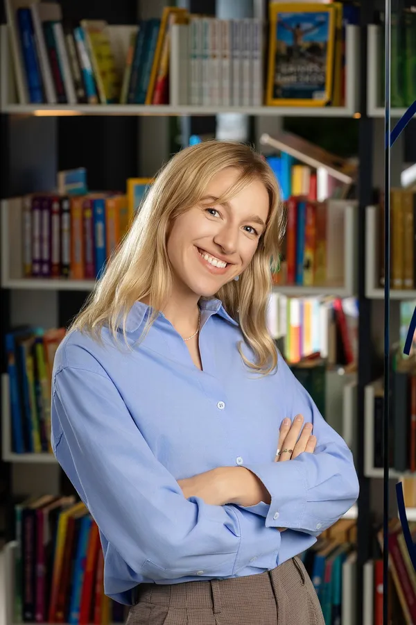 Smiling woman in a blue shirt in an office library