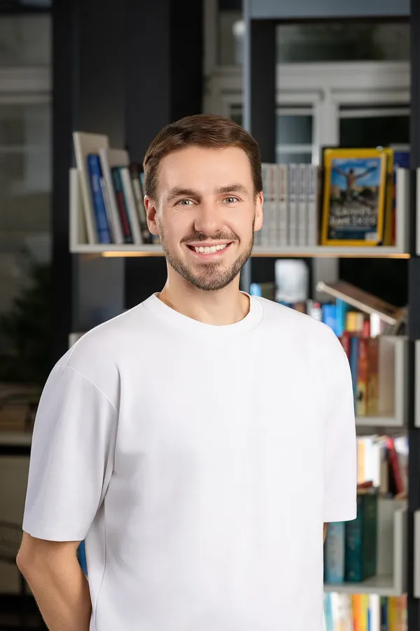 Smiling man in a white T-shirt in an office