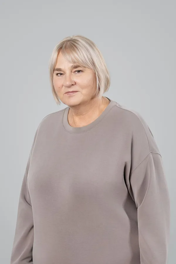 Portrait of an older woman on a grey studio background