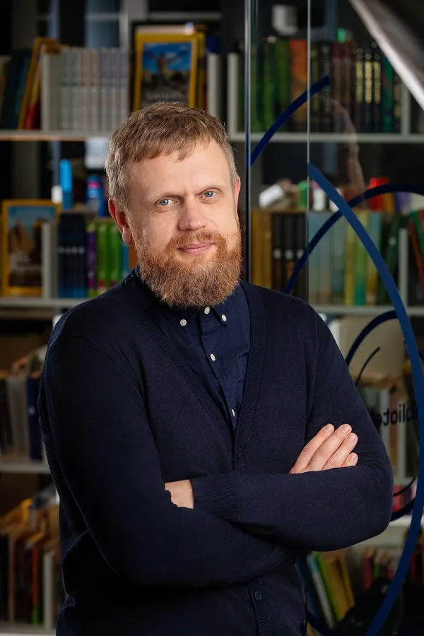 Portrait of a bearded man in a dark sweater in an office