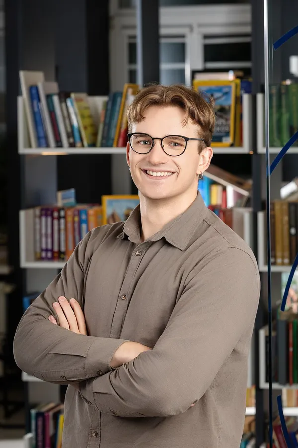 Portrait of a young man with glasses in an office