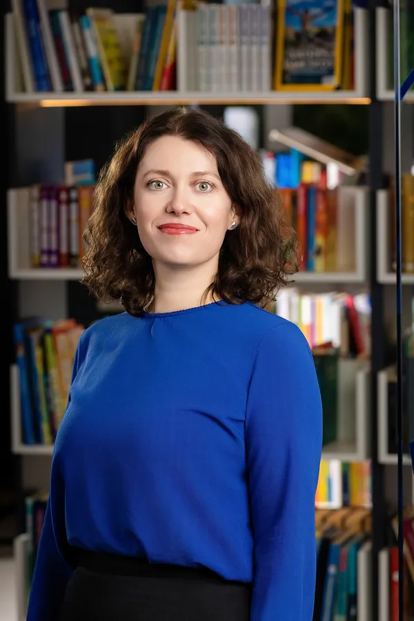 Portrait of a woman in a blue blouse in an office