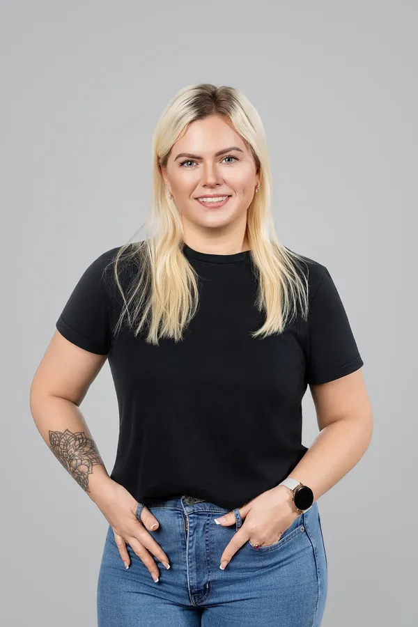 Portrait of a woman in a black T-shirt on a studio background