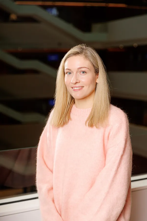 Blonde woman in a pink jumper