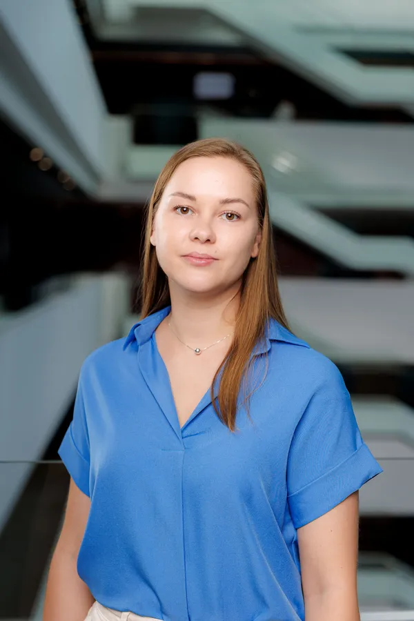 Woman in a blue shirt in a bright office atrium