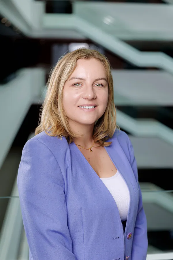 Smiling woman in a lavender blazer
