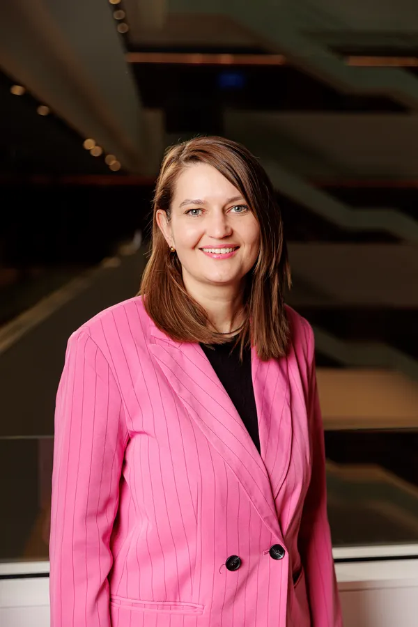 Smiling woman in a pink blazer