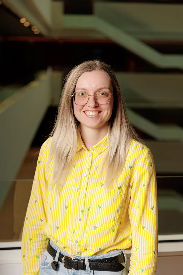 Woman with glasses in a yellow shirt